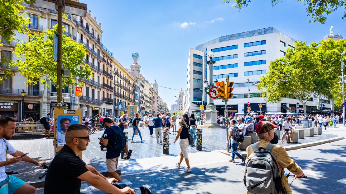 Travelt veikryss med fotgjengere og syklister ved Passeig de Gràcia i Barcelona.
