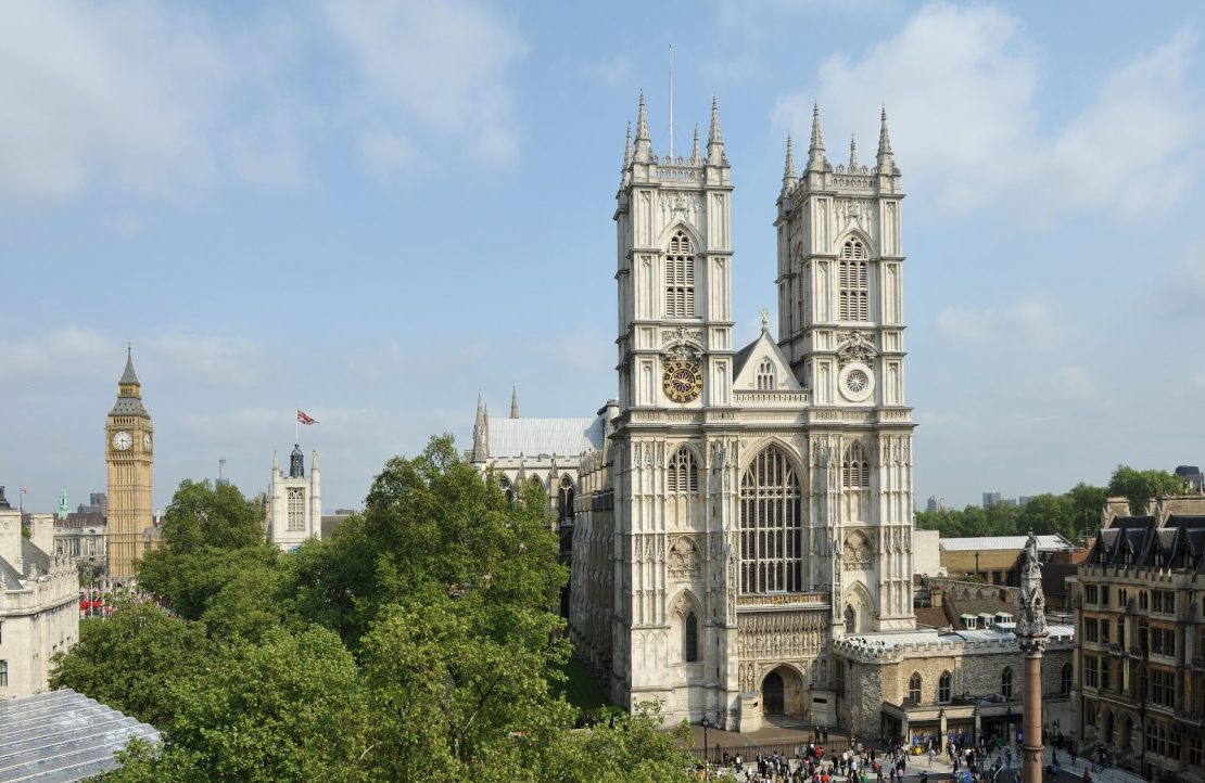 Westminster Abbey med Parlamentsbygningene i bakgrunnen i London, Storbritannia.
