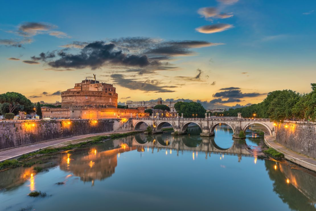 Roma, Vatikanstaten, Italia: Bysilhuett ved solnedgang med Castel Sant’Angelo og Tiberen.